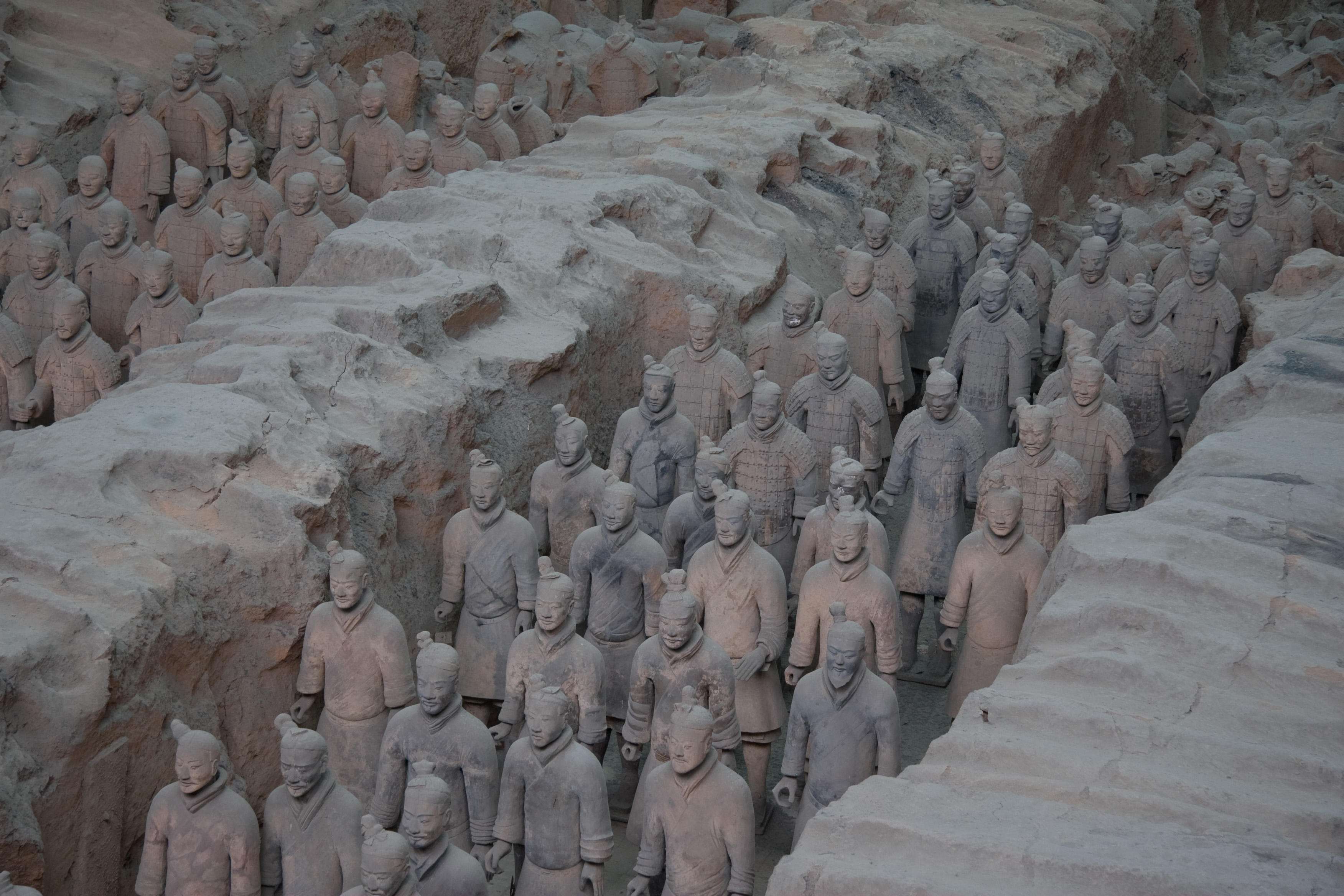 Terracotta warriors standing in formation inside the excavation pit